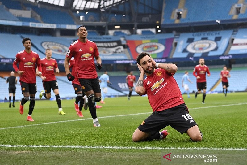 Gelandang Manchester United Bruno Fernandes (kanan) melakukan selebrasi seusai mencetak gol tendangan penalti ke gawang Manchester City dalam Derbi Manchester lanjutan Liga Inggris di Stadion Etihad, Manchester, Inggris, Minggu (7/3/2021) waktu setempat. 