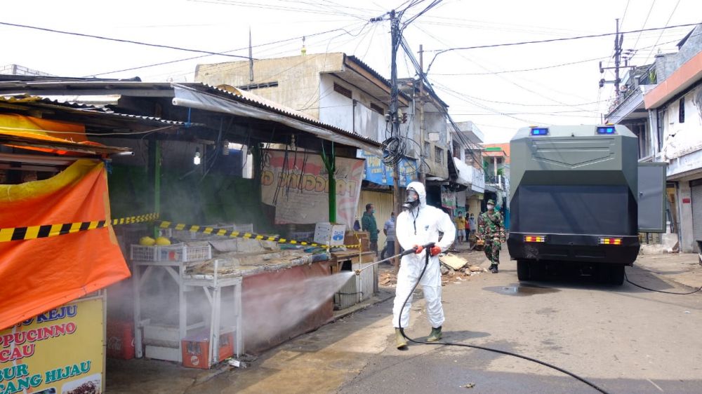 Penyemprotan yang dilakukan Polda jatim di Pasar Tradisional PPI Jalan  Gresik. ( foto : ris/hmp)