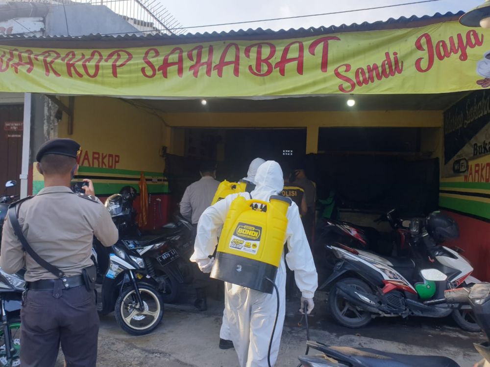 Sosialisasi PSBB di salah satu Warkop di Surabaya oleh petugas. ( foto : ris/hmp) 