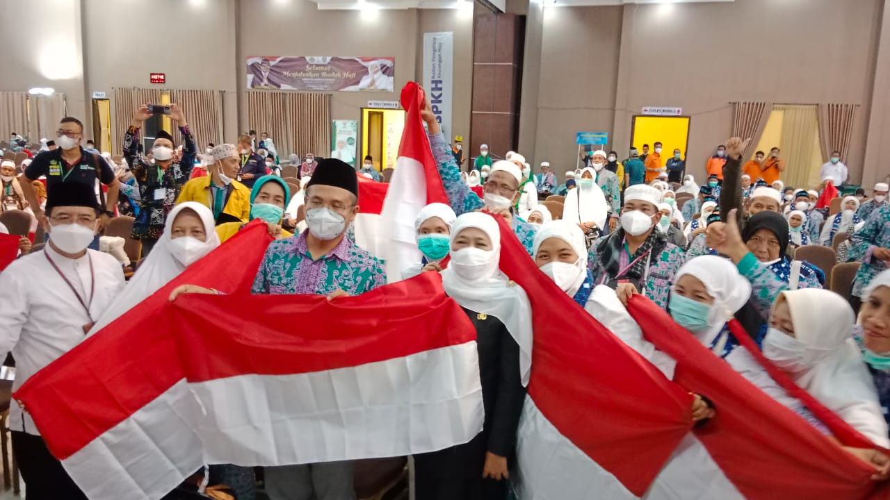Gubernur Jawa Timur Khofifah Indar Parawansa menyambut kedatangan jemaah haji kloter SUB-38 dengan membagikan bendera merah putih di Asrama Haji Sukolilo Surabaya, Sabtu (13/8) 