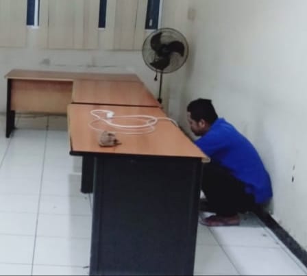 Pekerja lepas memindahkan barang-barang di ruang pers.